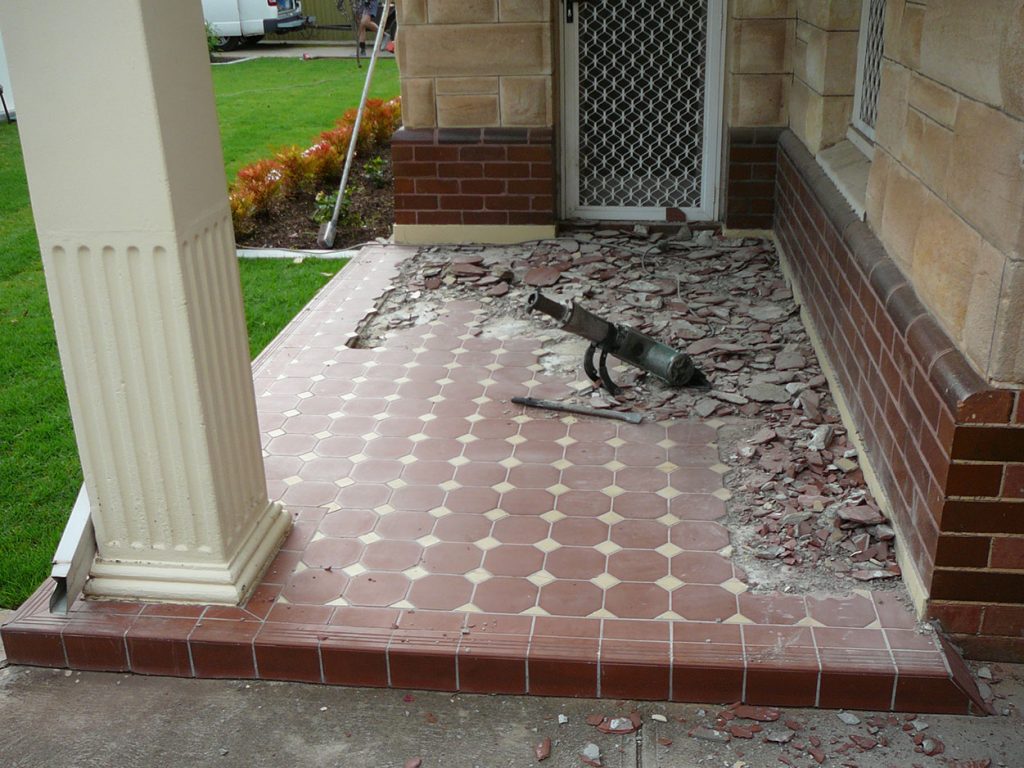 Demolition removal of tiles on verandah