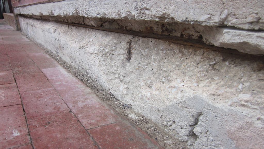 Concrete repairs: side wall of house - before
